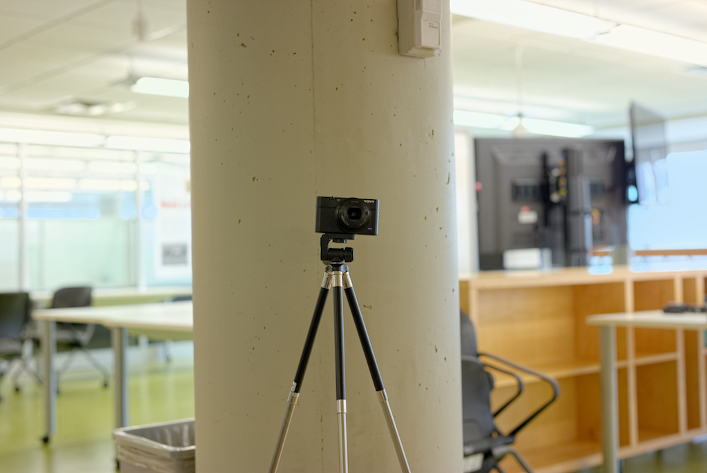 a picture of a point and shoot camera mounted on a small tripod.