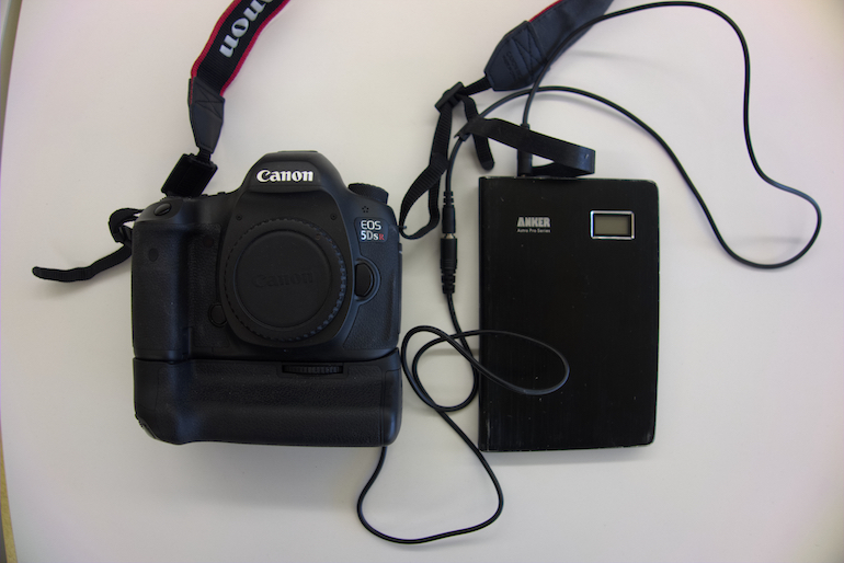 A camera connected to an external battery.
