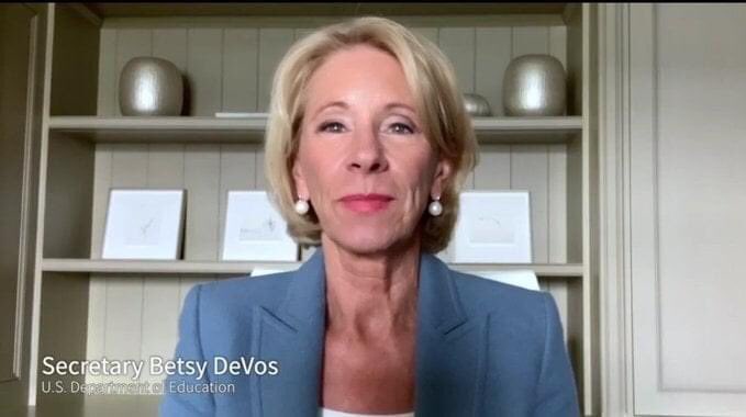 An image from a remote television appearance by Betsy DeVos.